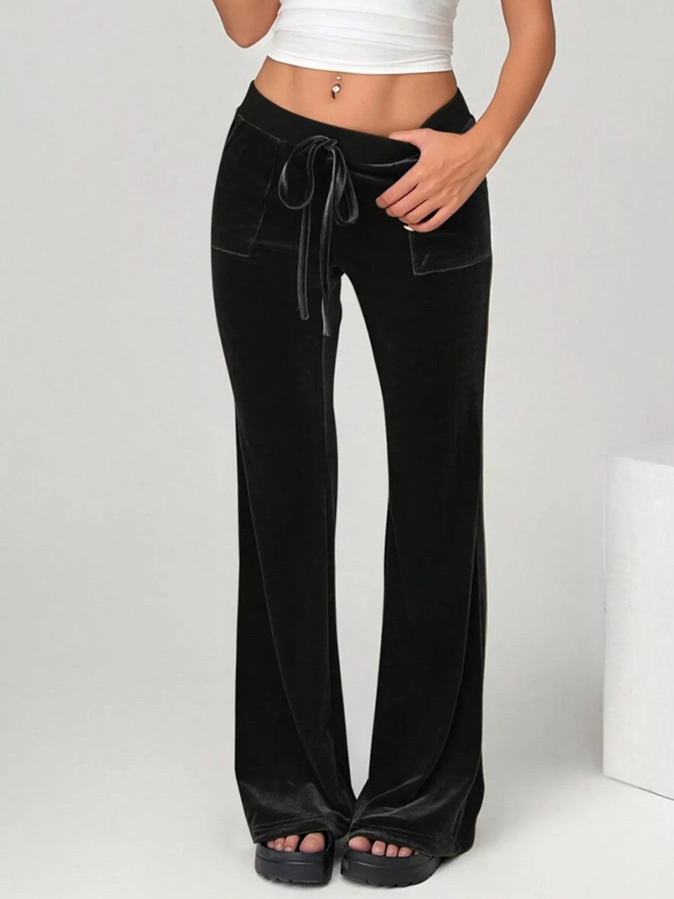 Black wide-leg pants with a drawstring waist on a white background
