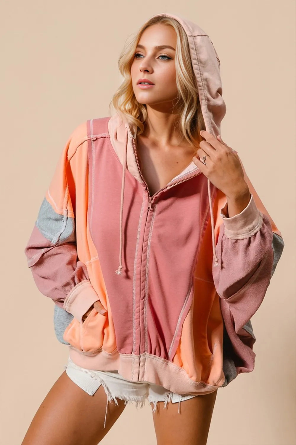 Woman wearing a colorful jacket with a neutral background