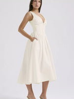 Woman wearing a white one-shoulder dress on a light gray background