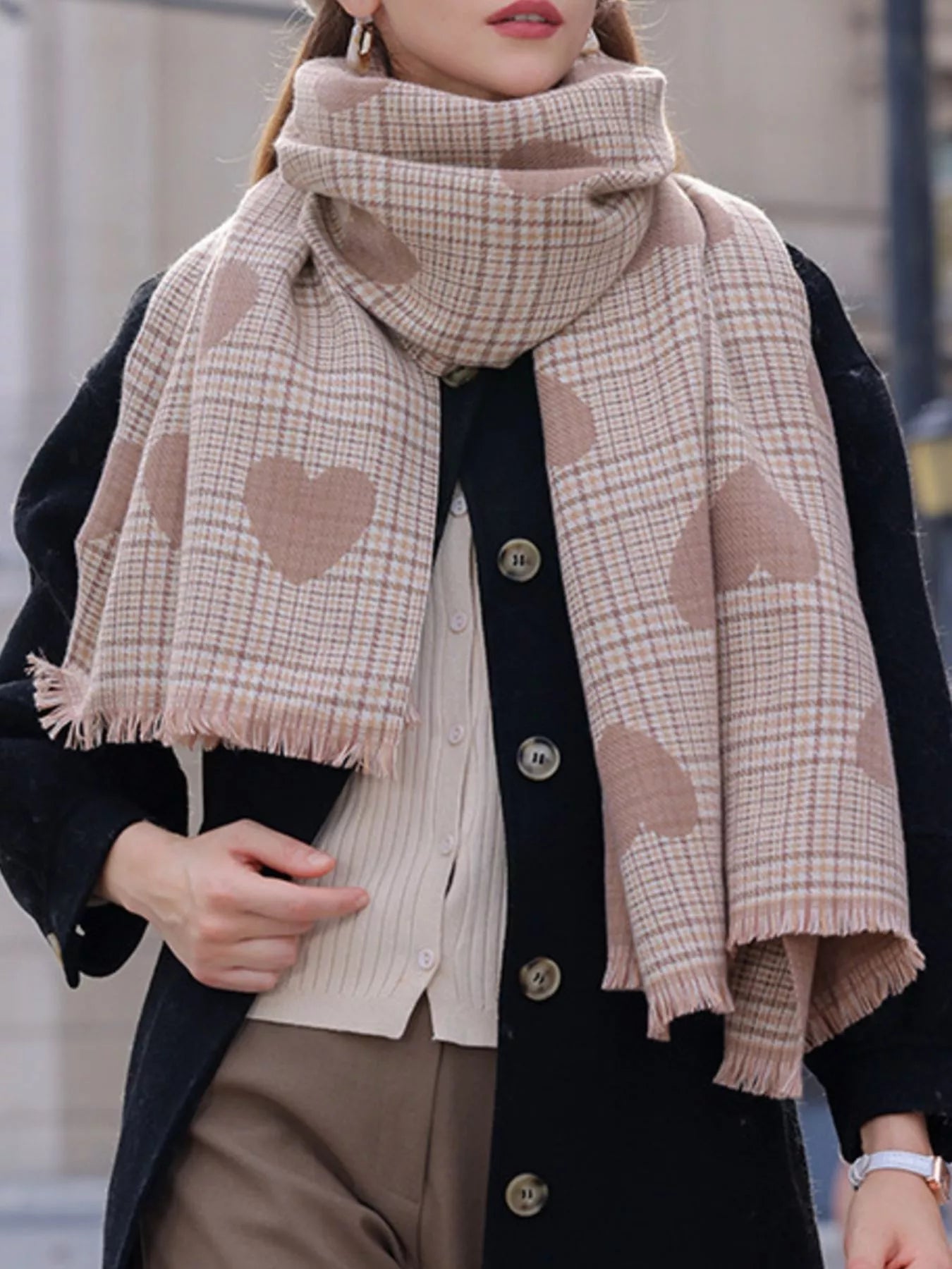 Person wearing a plaid scarf with heart patterns