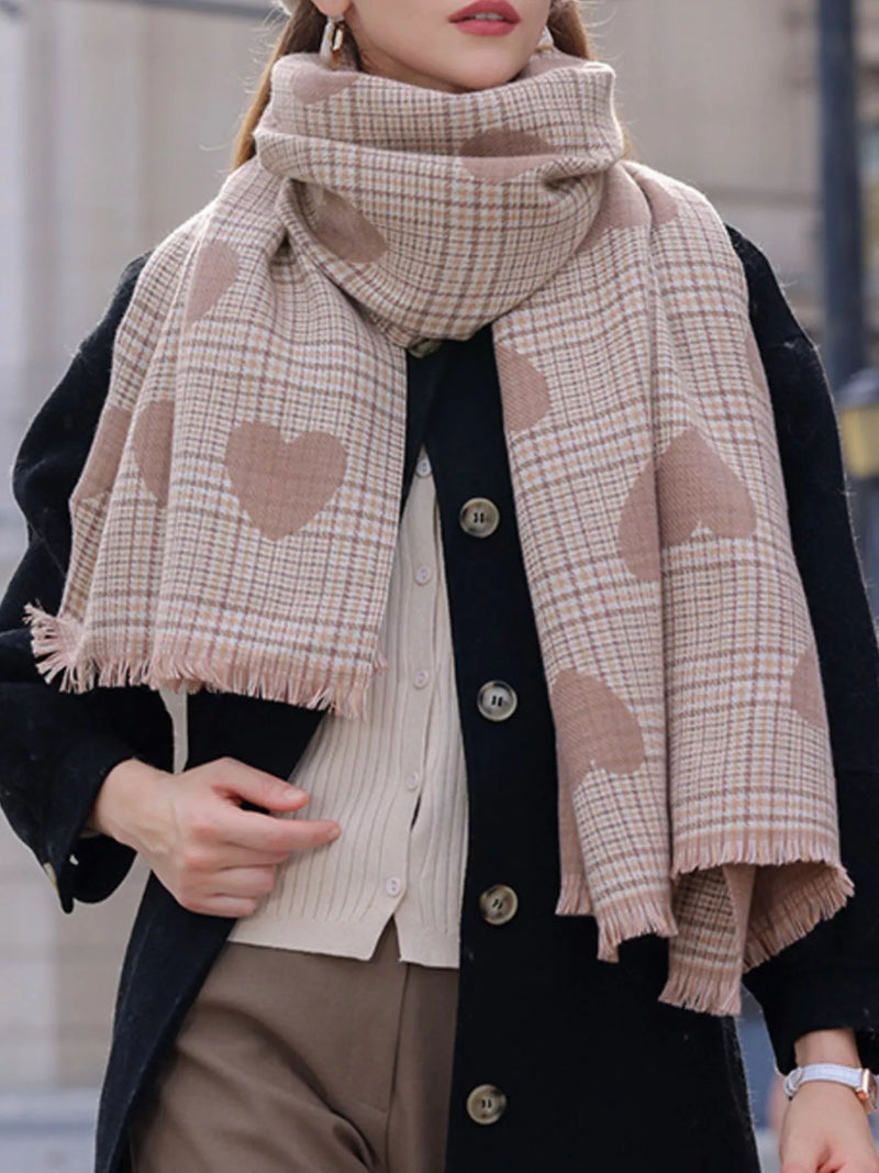 Person wearing a plaid scarf with heart patterns