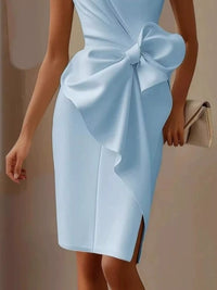 Light blue dress with a large bow detail on a neutral background