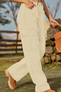 Person wearing beige cargo pants with a blurred outdoor background