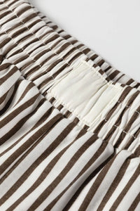 Close-up of brown and white striped fabric with a visible seam.