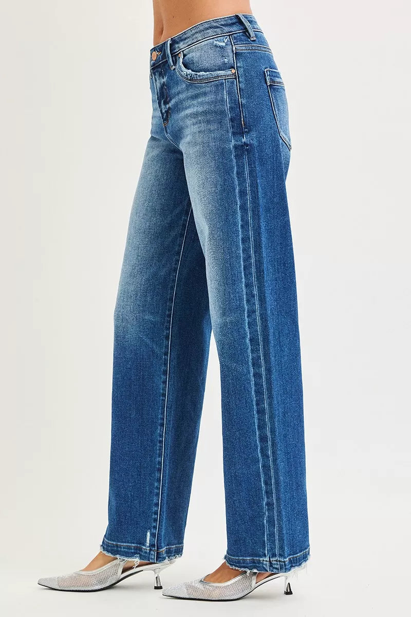 Blue jeans worn by a person on a white background