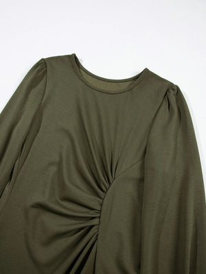 Green long-sleeve top with a knot detail on a white background
