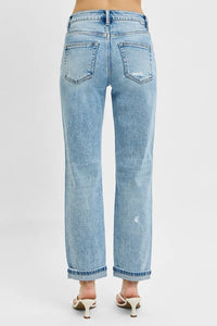 Light blue jeans worn by a person on a white background