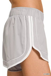 Light gray athletic shorts with white trim on a white background