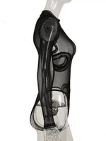 A sheer black long-sleeve bodysuit with a snakeskin pattern, displayed on a clear mannequin against a white background.