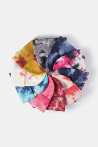 Stack of colorful tie-dye fabric swatches on a white background