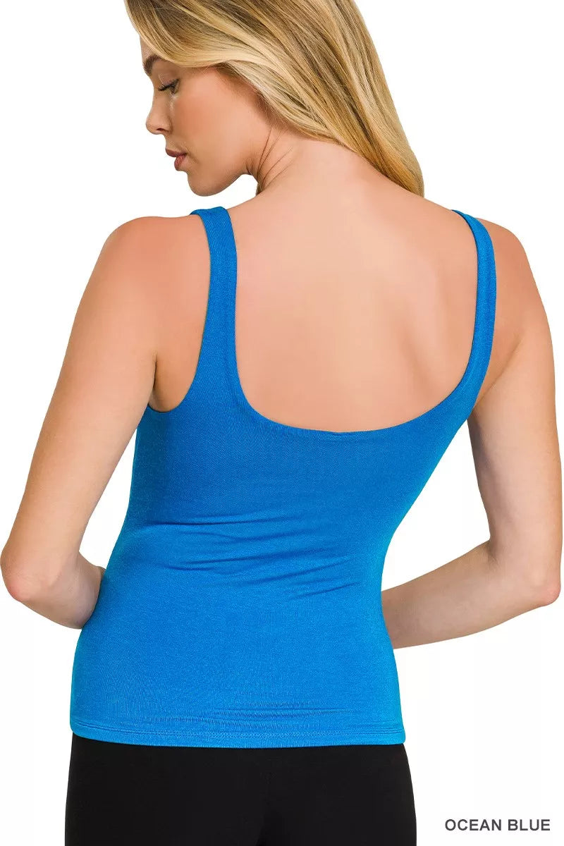 Blue tank top worn by a person on a white background
