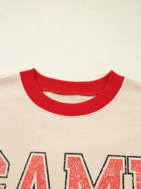 Close-up of a shirt with red collar and text on a beige background