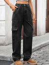 Person wearing black cargo pants on a street.