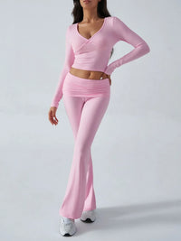 Person wearing a pink long-sleeve top and pants on a white background