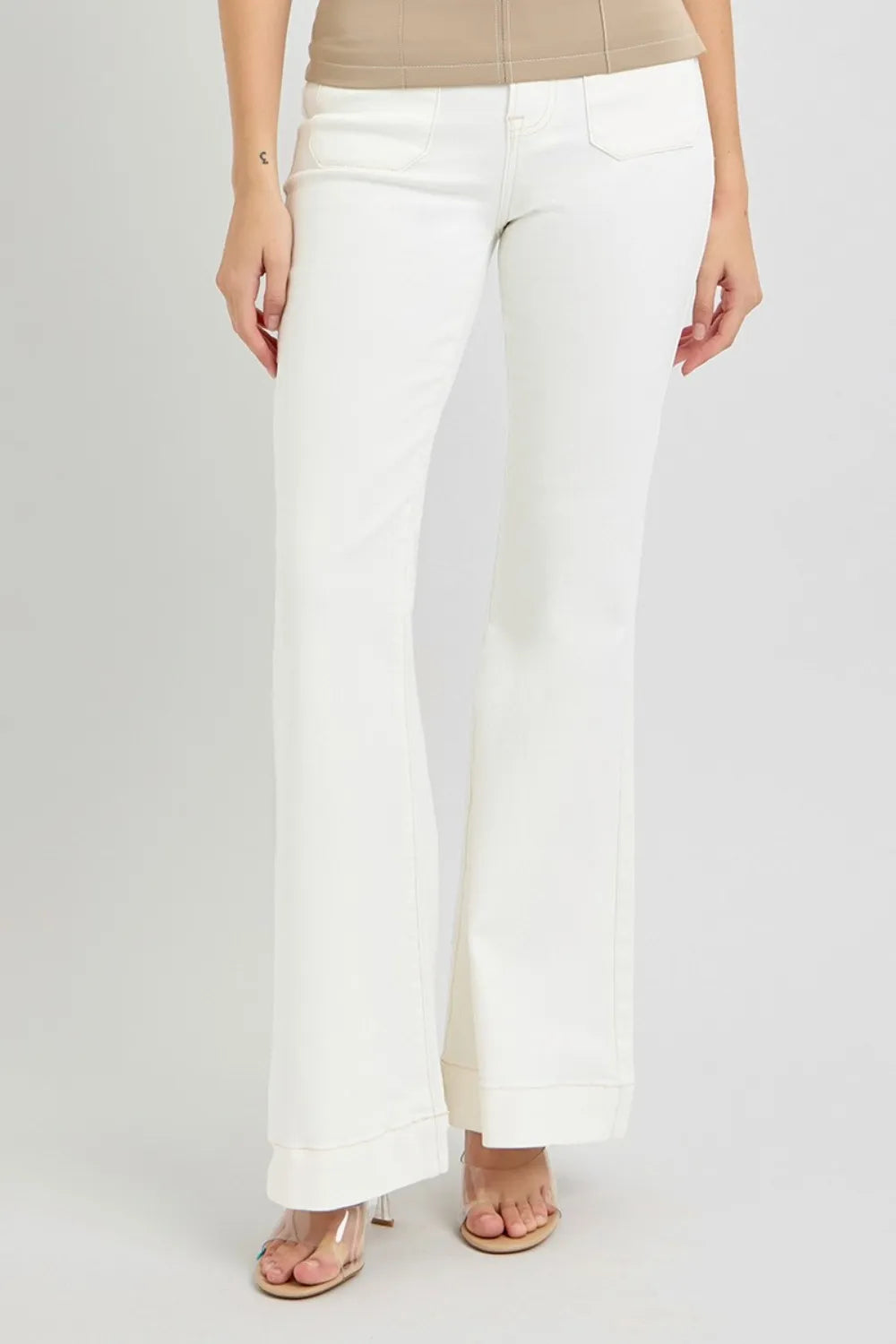 White pants worn by a person on a white background