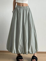 Light gray wide-leg pants worn by a person on a plain background