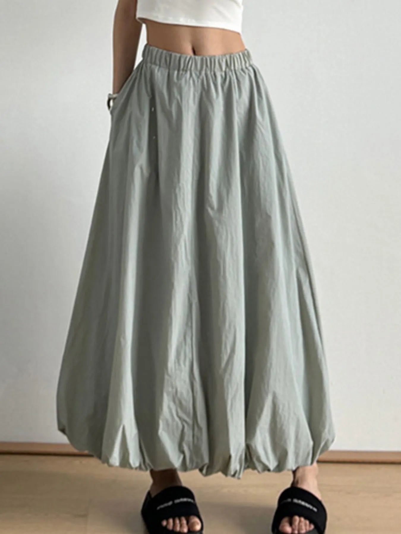 Light gray wide-leg pants worn by a person on a plain background