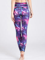 Galaxy-themed leggings worn by a person on a white background