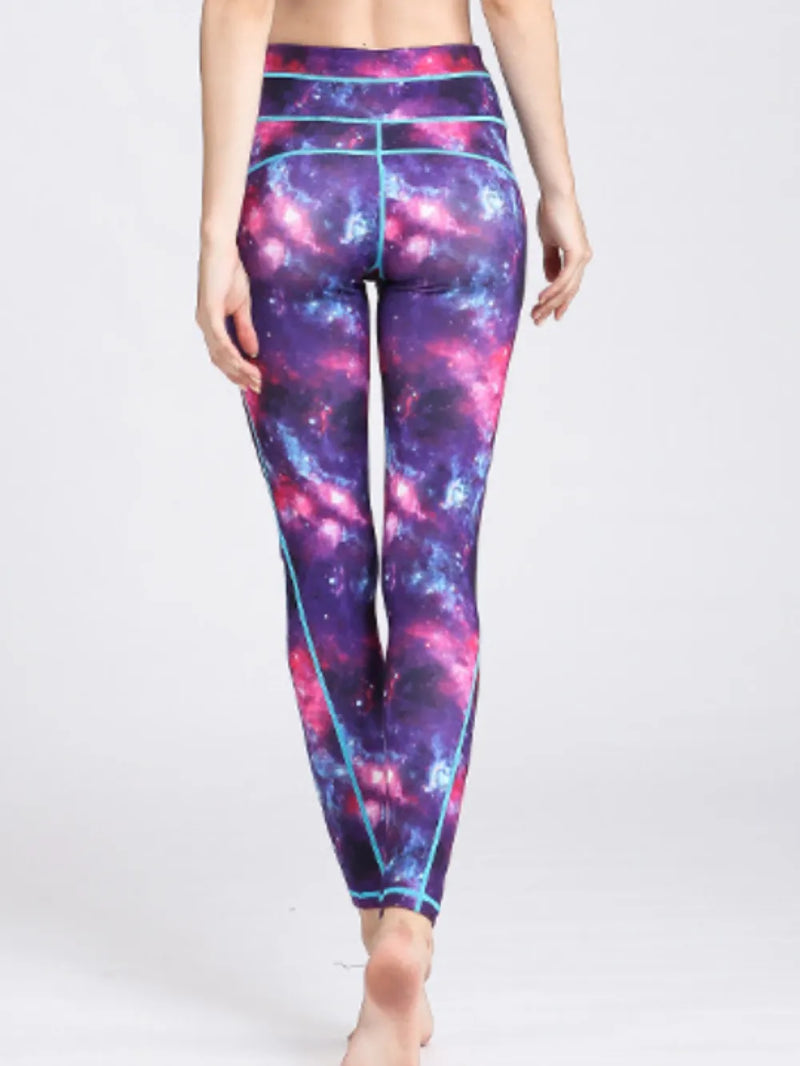 Galaxy-themed leggings worn by a person on a white background