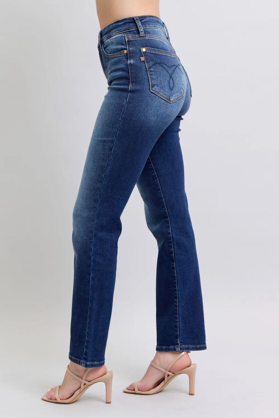 Blue jeans worn by a person on a light gray background