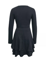 Black dress with long sleeves and a flared skirt on a white background