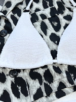White bralette on a black and white patterned fabric background