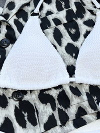 White bralette on a black and white patterned fabric background