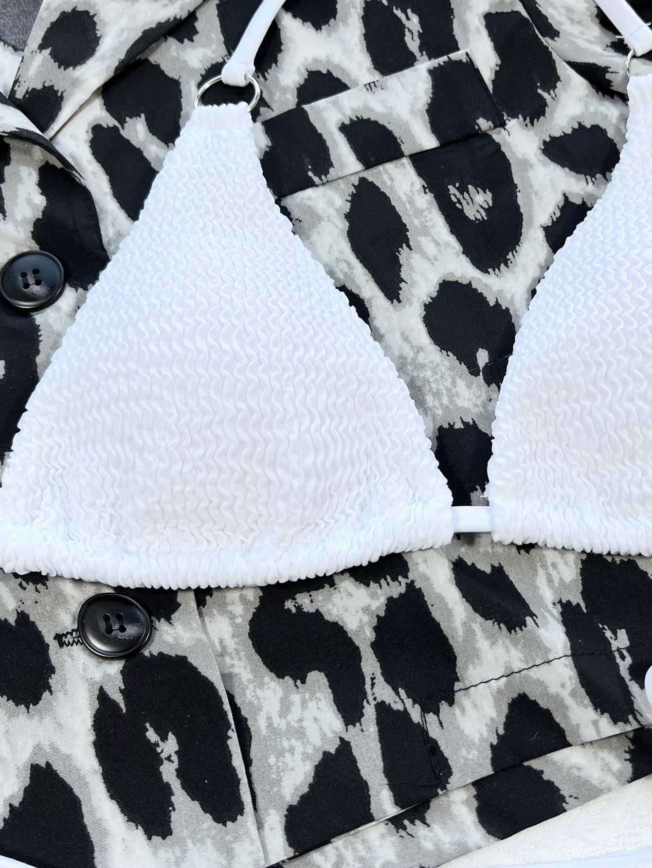 White bralette on a black and white patterned fabric background