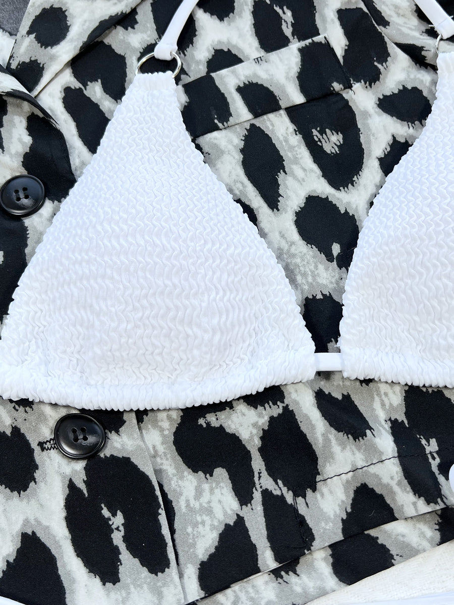 White bralette on a black and white patterned fabric background
