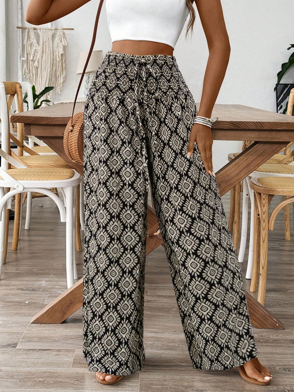 Person wearing patterned wide-leg pants in a casual setting