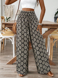 Person wearing patterned wide-leg pants in a casual setting