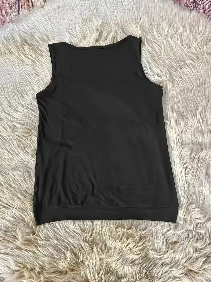 Black sleeveless top on a fluffy white surface