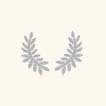 Pair of silver leaf-shaped earrings on a white background