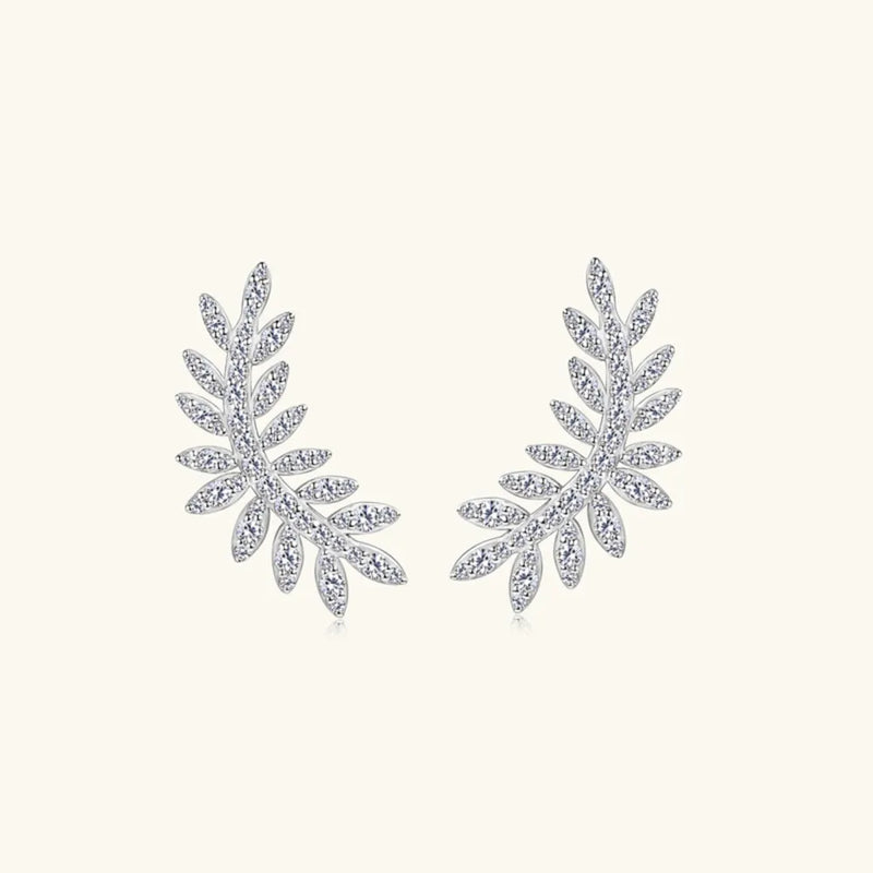 Pair of silver leaf-shaped earrings on a white background