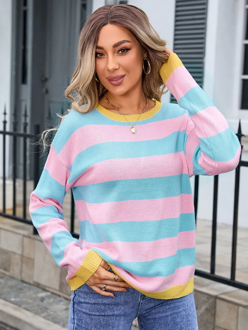 Woman wearing pink and blue sweater