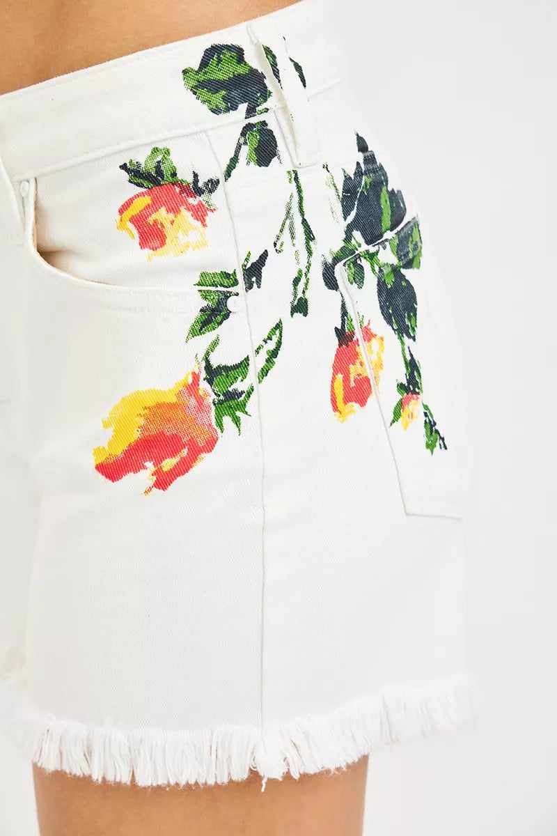 White denim shorts with colorful floral embroidery on a white background