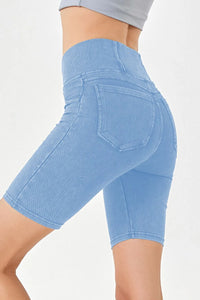 Light blue denim shorts worn by a person on a white background