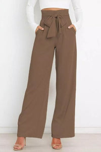 Brown wide-leg pants with a tie waist worn by a person on a white background