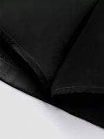Close-up of black fabric texture on a white background