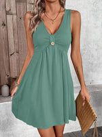Woman wearing a green dress with a wooden background