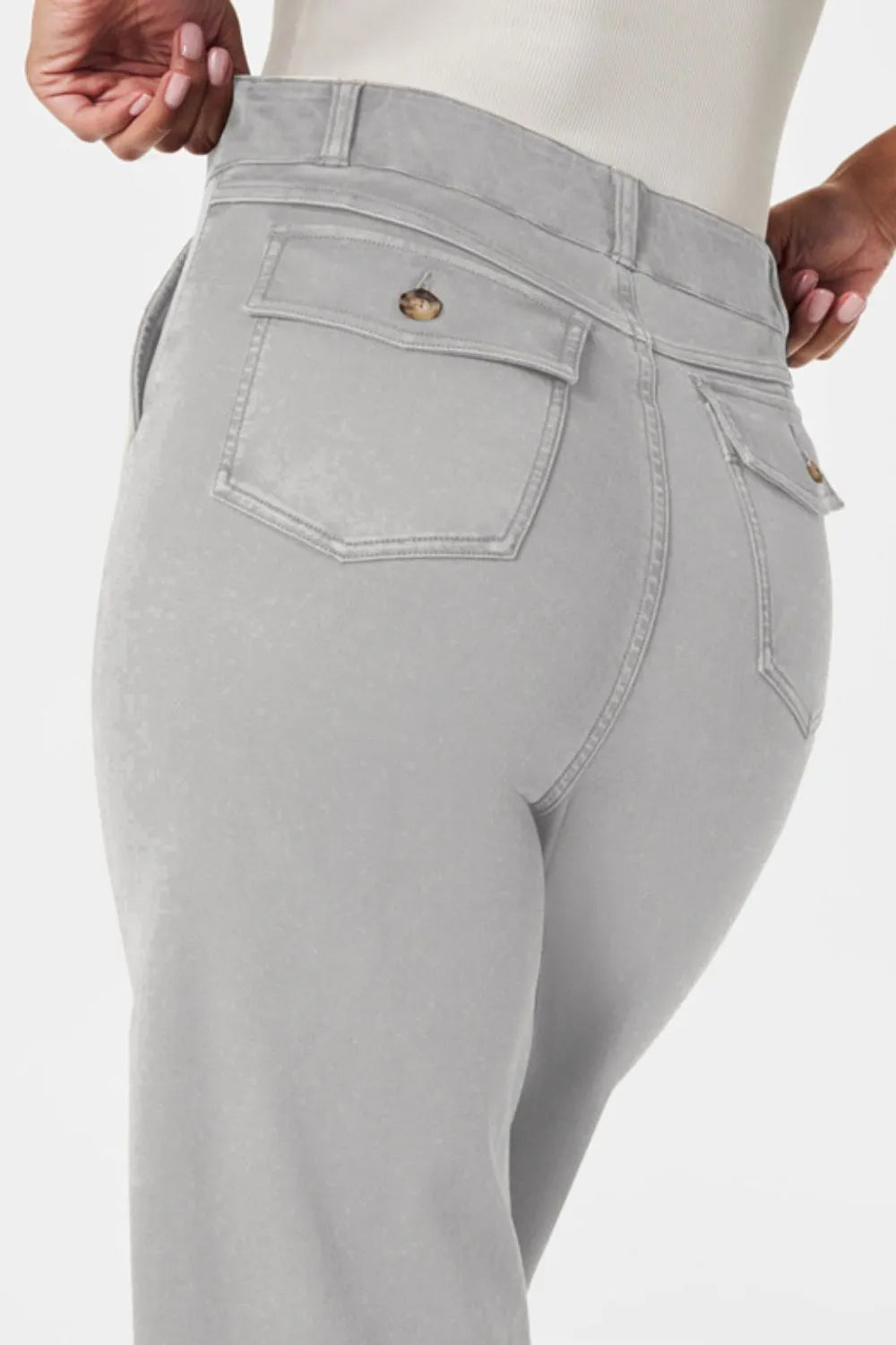 Light gray jeans with a brand logo on a white background