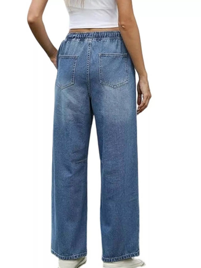 Person wearing blue jeans on a white background