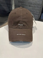 Brown cap with text on a white surface