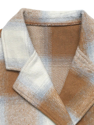 Close-up of a plaid fabric with brown, beige, and white colors.