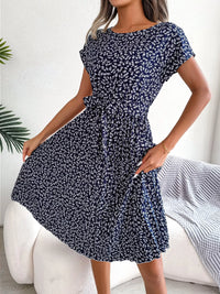 Woman wearing a blue floral dress in a casual setting