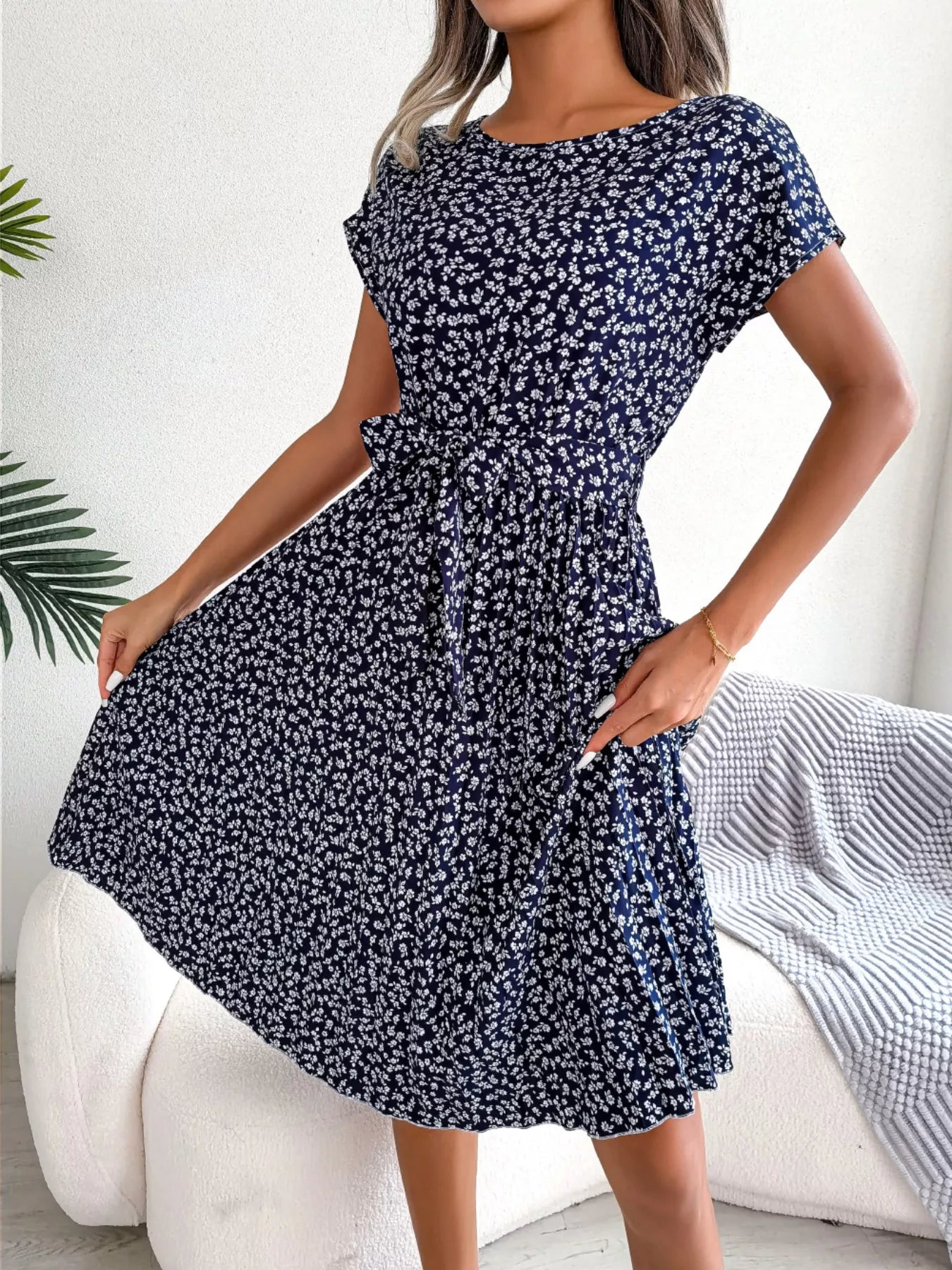 Woman wearing a blue floral dress in a casual setting