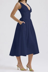 Navy blue dress worn by a person on a white background