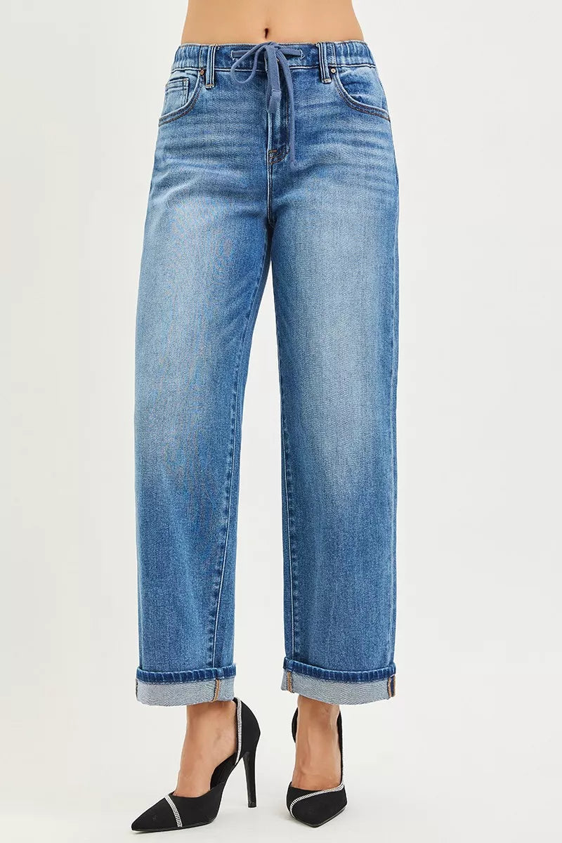 Blue jeans worn by a person on a white background