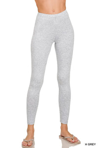 Gray leggings worn by a person on a white background