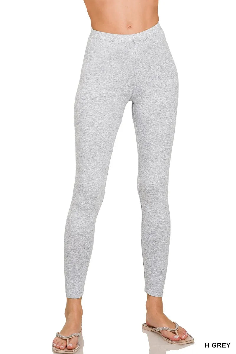 Gray leggings worn by a person on a white background